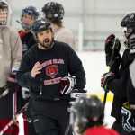 Juneau-Douglas High School hockey head coach Luke Adams speaks to his team on the ice during practice at Treadwell Arena on Wednesday, Nov. 2, 2016.