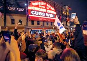 Chicago Cubs fans celebrate in front of Wrigley Field in Chicago on Wednesday, Nov. 2, 2016, after the Cubs defeated the Cleveland Indians 8-7 in Game 7 of the baseball World Series in Cleveland. (AP Photo/Charles Rex Arbogast)