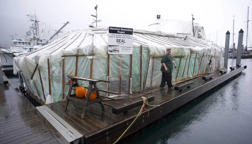 Russell Peterson with his 1926 boat, the Seal, in Aurora Harbor on Thursday, Nov. 3, 2016. Peterson has lived in Aurora Harbor for 13 years.