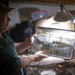 Russell Peterson shows a picture on Thursday, Nov. 3, 2016, of what his 1926 boat, the Seal, looked like in its prime. Peterson has lived in Aurora Harbor for 13 years.