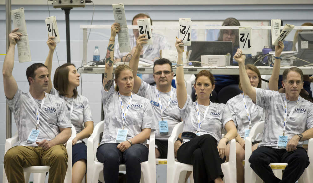 Diving judges show their scores to the announcer during the 2016 ASAA/First Natinal Bank Alaska Swim & Dive State Championships at the Dimond Park Aquatics Center on Friday, Nov. 4, 2016.