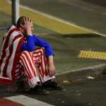 A man dressed in red-white-and-blue sits on the curb during a protest against President-elect Donald Trump, Wednesday, Nov. 9, 2016, in Seattle's Capitol Hill neighborhood. (AP Photo/Ted S. Warren)