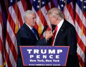 President-elect Donald Trump shakes hands with Vice President-elect Mike Pence as he gives his acceptance speech during his election night rally, Wednesday, Nov. 9, 2016, in New York. (AP Photo/John Locher)