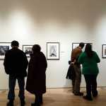 Visitors look at photos during the opening of the 2016 Alaska Positive exhibit at the state museum on Nov. 4.