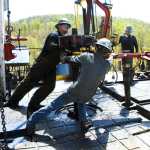 In this file April 23, 2010 photo, workers move a section of well casing into place at a Chesapeake Energy natural gas well site near Burlington, Pennsylvania, in Bradford County. President-elect Donald Trump has not minced words about his approach to environment and energy policy: He loathes regulation, and wants to increase the use of coal, offshore drilling and fracking.
