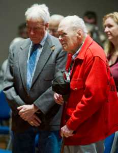 Veterans Howard Colbert, left, and Pat Carothers listen to the benediction at Veterans Day ceremonies at Centennial Hall on Friday. Carothers served in the WWII, Korea and Vietnam Wars.