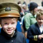 Dane Hubert, 9, wears his great-grandfather's ROTC hat while attending Veterans Day ceremonies with his brother, Jaeger, 7, and mother, Paula, at Centennial Hall on Friday.