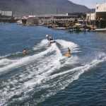 Water skiing by Juneau's downtown waterfront in 1955. The old Douglas Bridge can be seen in the background.