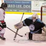Juneau-Douglas' Bill Bosse challenges Hutchison's goalie Alayah Brunty at Treadwell Arena on Friday, Nov. 18, 2016.