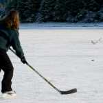 Randy Host passes a hockey puck to his wife, Heather Brandon, as they take advantage of the ice in front of Skater's Cabin at Mendenhall Lake on Monday.
