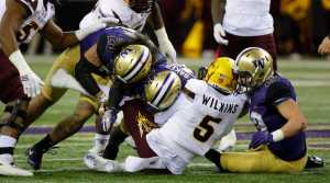 Arizona State quarterback Manny Wilkins (5) is sacked by Washington defensive back Budda Baker, third from right, with help from linebacker Connor O'Brien, right, and linebacker Psalm Wooching, left, in the first half of an NCAA college football game Saturday, Nov. 19, in Seattle. (Ted S. Warren | The Associated Press)