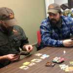 In this Oct. 24 photo, Tim Hanson, left, and Jim Clark play a game of Gut Pile in Fairbanks. The card game is a Fairbanks-designed product where players score points by assembling the elements for a perfect hunt while avoiding their opponent's attack cards like; hypothermia, beaver fever and the always-dangerous People for the Ethical Treatment of Animals card.