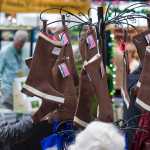 Tyler Thomas takes a peak at Barbara Mitchell's brown boot stockings on display at Public Market in Centennial Hall on Friday.