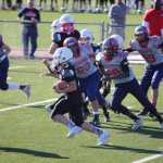 Juneau Raiders player Cody Morehouse rushes with the ball in their championship game against the Camarillo Cougars.