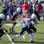 Juneau Raiders football player Cody Morehouse avoids defenders during their National Youth Football Championship game against the Camarillo Cougars.