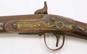 The serpent side plate seen here on Friday, Dec. 2, 2016 appears on a smoothbore musket sold by the Hudson's Bay Company in the late 19th century and now held in the collections of the Alaska State Museum. The serpent motif first appeared on Dutch muskets sold to American Indians in New England during the early 17th century, but it stayed emblazoned on trade muskets sold to Natives and Indians in North America for almost 300 years.