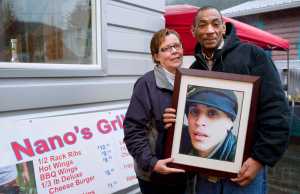 Kerry and Richard Wycoff hold a picture of their son, Michael, on Friday, Dec. 2, 2016, in front of a new business they are starting in his honor located at Louie's Douglas Inn.