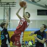 Floyd Dryden Middle School's Jackson Stanley (13) shoots over Dzantik'i Heeni Middle School's Owen Castello (25) during the Icebreaker Tournament held at DHMS on Friday.