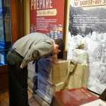 National Park Service employee Benjamin Hayes smells hooligan oil, a staple food for Tagish and Tlingit packers on the trail. it was a dip for dried fish and was used to keep berries, roots and salmon eggs fresh. The other jar is a sourdough starter for bread, biscuits and flapjacks.