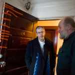 James Barrett, left, owner of the Bergmann Hotel, talks with hotel manager Charles Cotten Jr. about damage to the hotel, including the room's doors, during a recent visit.