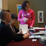 Crystal Worl, illustrator of the newly released two-book Tlingit alphabet, gets books signed by author Pauline Duncan and ilustrator Lindsay Carron.