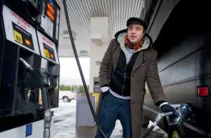 David Ansbach pumps gas into his van at the downtown Tersoro Alaska station on Friday, Dec. 16, 2016. As part of his new budget, Governor Bill Walker has proposed tripling the motor fuel tax from eight cents per gallon to 24 cents over the next two years to be more inline with the national average.