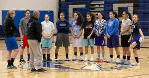 Thunder Mountain High School girls basketball Head Coach Chandler Christensen, left, and Assistant Coach Vince Yadao speak with their team before practice at TMHS on Tuesday, Dec. 13, 2016.