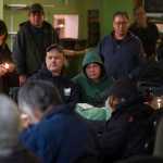 The Glory Hole Executive Director Mariya Lovishchuk, left, lights candles as the names of homeless people who have died are called out during the Longest Night Remembrance Service at the shelter on Friday, Dec. 16, 2016.