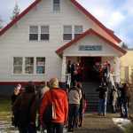 People watch the Oxford Carolers sing during Julebukking on Christmas Eve 2015 outside Sing Lee Alley Books and Gifts.