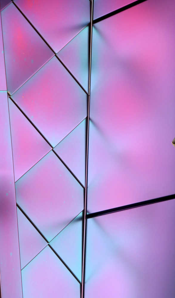 Iridescent tiles and their reflection.