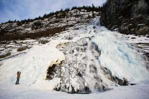 Steven Rupp photographs a partially-frozen Nugget Falls at Mendenhall Lake on Saturday, Dec. 24, 2016.
