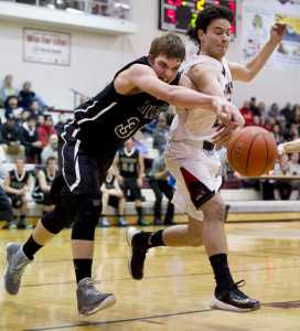 Juneau-Douglas' Marshall Shapland-Murray, right, and Haines' Dylan Swinton chase a loose ball during the Capital City Classic at JDHS on Tuesday, Dec. 27, 2016.