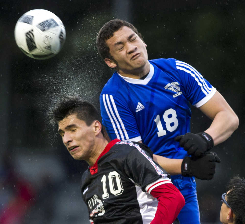 Juneau-Douglas' Oswaldo Magallanes and Thunder Mountain's Mahina Toutaiolepo compete for the ball during their game at Adair-Kennedy Memorial Park on May 17.