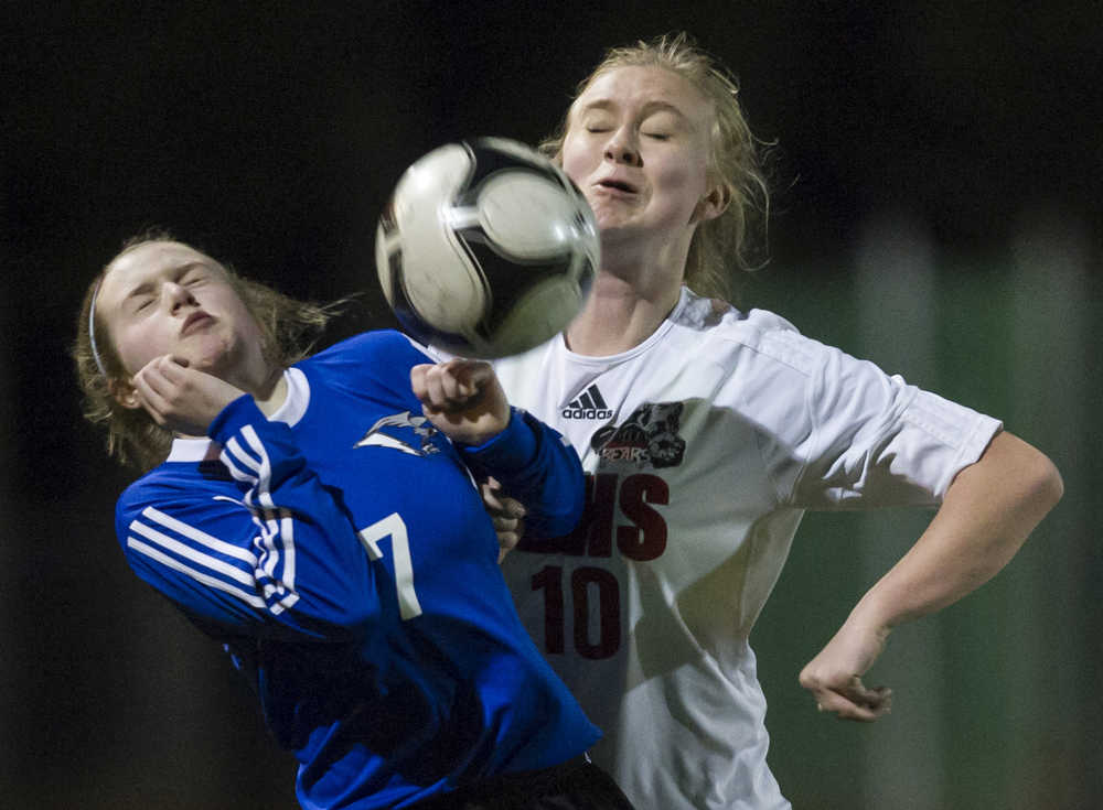 Thunder Mountain's Raye Coffee, left, and Juneau-Douglas' Erika Holst compete for the ball at Adair-Kennedy Memorial Park on April 8.