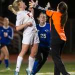 Juneau-Douglas' Erika Holst attempts to head the ball over Thunder Mountain's goalie Tianna Huber as Thunder Mountain's Meghan Penrose looks on at Adair-Kennedy Memorial Park on April 8.