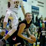Juneau-Douglas' Erik Kelly fakes Dimond's Kylan Osborne into the air during the Capital City Classic at JDHS on Friday, Dec. 30, 2016.