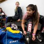 Kaylee Lahnum, 13, laces up her ice skates before the Juneau Douglas Ice Association 10U girls hockey game against the 10U boys team on Dec. 17, 2016 at the Treadwell Arena. The 10U boys team won 7-5.