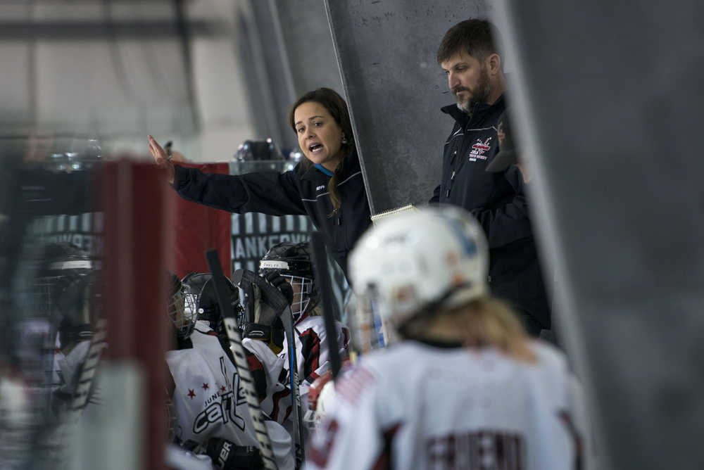 Juneau Douglas Ice Association 10U girls hockey head coach Jill Weitz speaks to her team as assistant coach Greg Stopher looks on during the hockey game against the 10U boys team on Dec. 17, 2016 at the Treadwell Arena. The 10U boys team won 7-5.