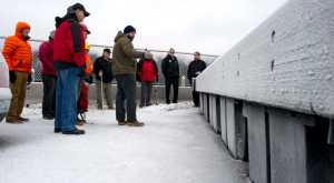 Matthew Sill, center, an engineer with PND Engineers, explains their design of the new floats that are being used in the remodel of the Douglas Harbor during a tour on Wednesday, Jan. 4, 2017.