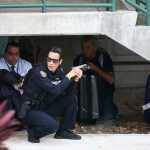 Law enforcement personnel shield civilians Friday outside a garage area at Fort Lauderdale-Hollywood International Airport in Florida, after a shooter opened fire inside a terminal of the airport, killing several people and wounding others before being taken into custody.