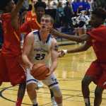 Thunder Mountain senior Riley Olsen works the attempts to score against visiting West Valley boys basketball Friday.