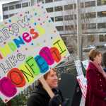 Juneau Police Department Lt. Kris Sell, left, and others hold a rally in front of the Capitol to send positive thoughts to the 30th Alaska Legislature on Tuesday. The rally is part of the department's "Year of Kindness" initiative.