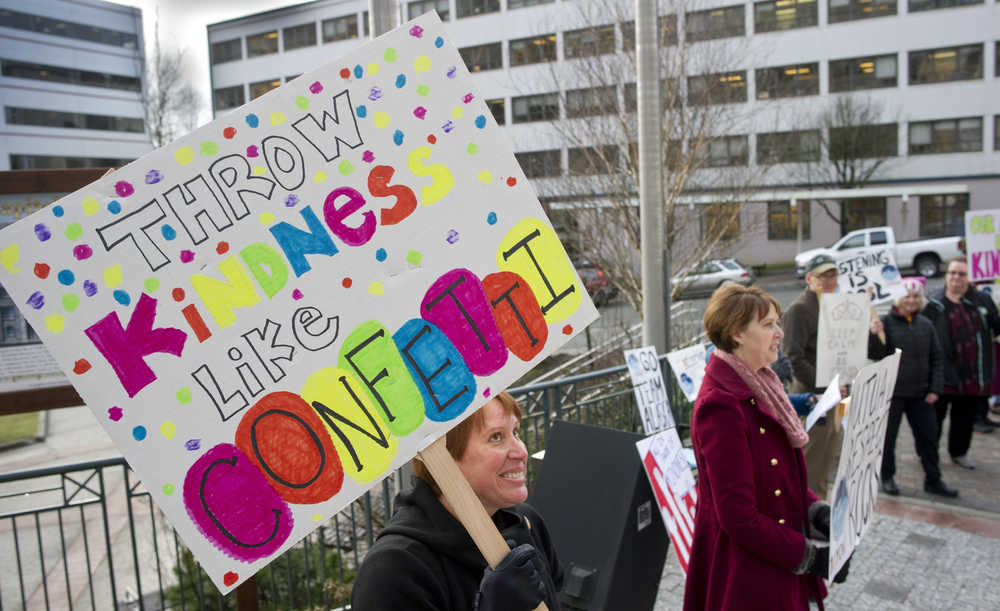 Juneau Police Department Lt. Kris Sell, left, and others hold a rally in front of the Capitol to send positive thoughts to the 30th Alaska Legislature on Tuesday. The rally is part of the department's "Year of Kindness" initiative.