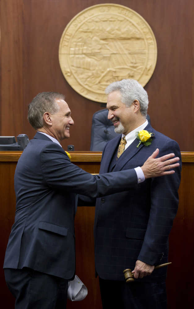Sen. Kevin Meyer, R-Anchorage, left, turns over the Senate President's gavel to Sen. Pete Kelly, R-Fairbanks, on the first day of the first session of 30th Alaska Legislature at the Capitol on Tuesday.