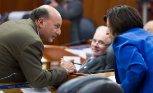 Rep. Les Gara, D-Anchorage, left, talks with Rep. Liz Vazquez, R-Anchorage, as Rep. Bob Herron, D-Bethel, looks on during the first day of the 29th Legislature at the Capitol in Juneau on Tuesday, Jan. 19, 2016.