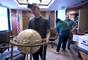 Jim Hoff with the Department of Administration, right, directs Erik Pedersen, left, and Josh Tagalon of World Wide Movers as they move furniture out of the Governor's Office at the Capitol on Thursday. The Governor's Office is now located in the Community Building on Third Street as construction at the Capitol continues.
