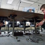 Tim Powers, right, and Brian Heimbigner of Legislative Affairs set up a committee hearing room at the Bill Ray Center on Thursday. The Legislature is moving to the center as construction at the Capitol ramps up for the summer.