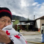 Warlita Luciano waits with her husband, Teddy, as Capital City Fire/Rescue personnel put out a fire at their trailer home in the Thunder Mountain Mobile Park Wednesday. The fire started about 10 a.m. and there were no reported injuries.