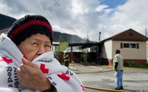 Warlita Luciano waits with her husband, Teddy, as Capital City Fire/Rescue personnel put out a fire at their trailer home in the Thunder Mountain Mobile Park Wednesday. The fire started about 10 a.m. and there were no reported injuries.