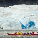 Tourists aboard an Alaska Travel Adventures canoe row in front of the Mendenhall Glacier on Thursday. The first jökulhlaup of the season has begun according to the National Weather Service. This year's glacial outburst flood may be bigger than any from 2015.